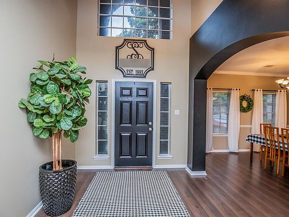 Foyer with great natural lighting. Beautiful arched entry into formal dining room