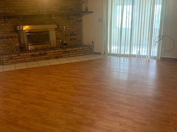 Big Living Room Picture. Fireplace has Heatalator. Sliding door to Enclosed but unfinished patio. Huge windows around Patio