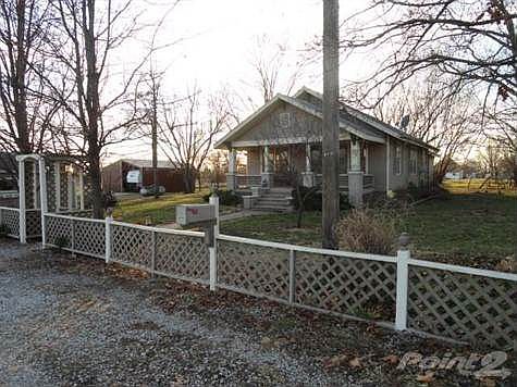 Home with huge yard and barn in distance.