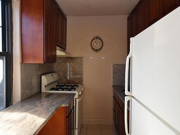Galley Kitchen with stone countertops