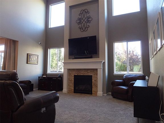 Dramatic 2-story family room with new carpet, new paint, gas fireplace, hidden media cables can connect on either side of the fireplace!
