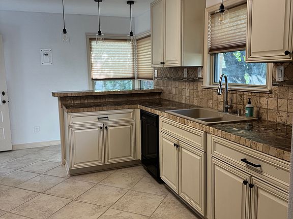 Kitchen with Refrigerator, Gas Range, Dishwasher, and microwave included. Granite tile countertops