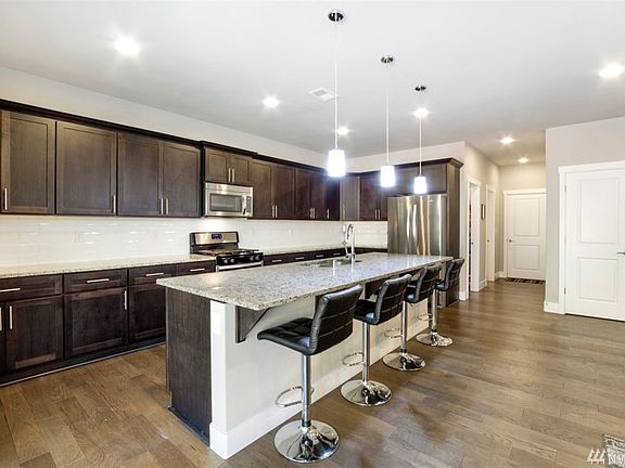 Kitchen includes stainless appliances, granite counter tops, walk in pantry and delightful oversized breakfast bar!