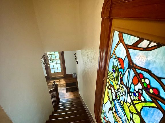 Stained glass window. Stairs looking down from unit