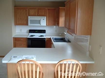 Eath in kitchen with breakfast bar.
