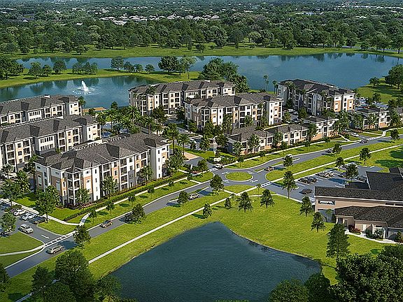 Integra Avalon, an inviting apartment community with modern architecture, lush landscaping, and serene palm-lined pathways, perfect for comfortable living.