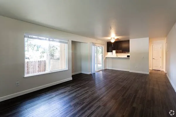 Spacious living and dining areas with alcove and open kitchen access.