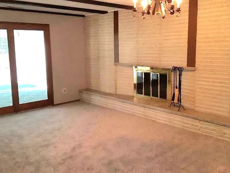 Large family room with a brick wood burning fireplace (gas asst.). Glass doors lead out to screen/glass doors sun room. Not show to right of brick fireplace, door to pantery storage, utility room w/d hook-up, 1/2 bathroom and side door to outside.