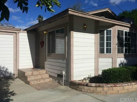Impecably manicured landscaping with brick accented planters.