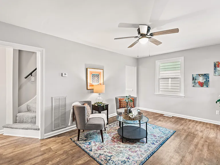 Large living room area with ceiling fan, working table and high speed internet.