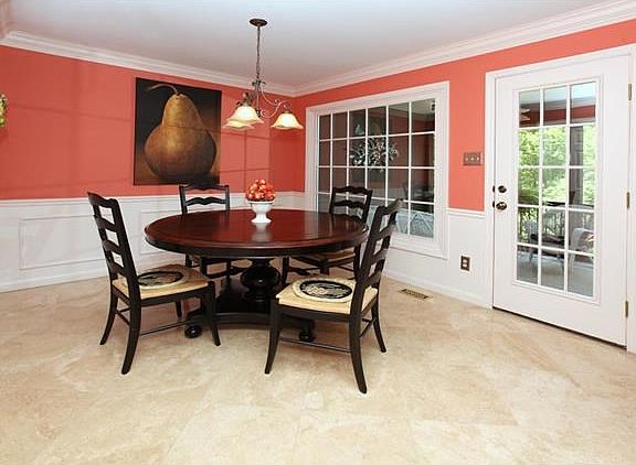The cheery breakfast room has an adjoining screened porch