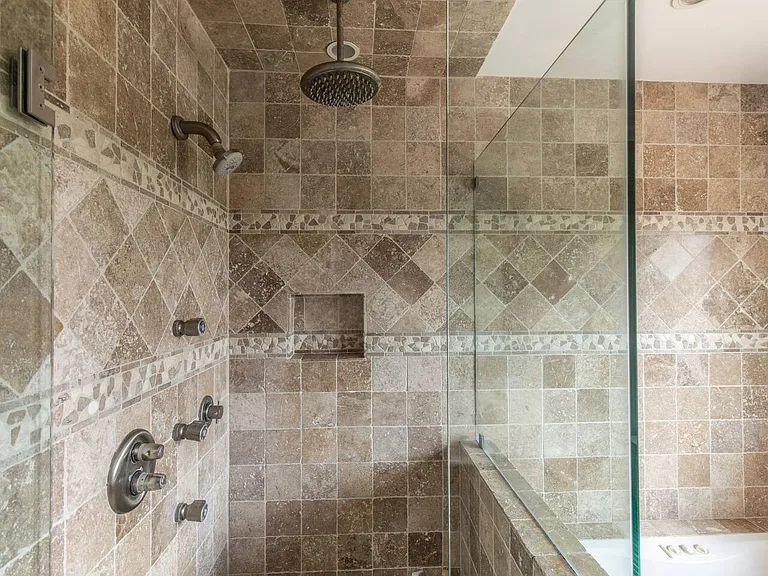 Upstairs bathroom with walk in shower and bath tub.