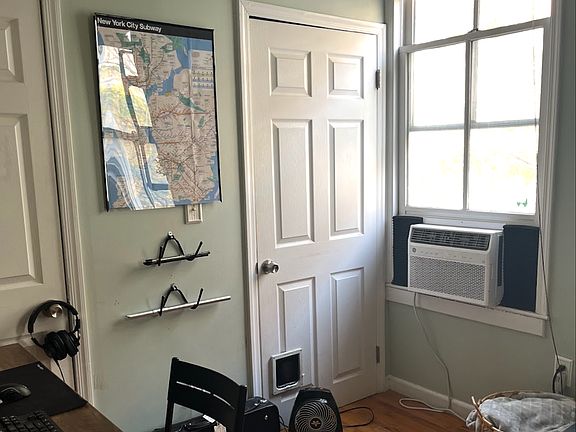 Second room used as living room/office space. Doors seen are one long closet