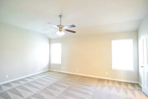Master bedroom with happy ceiling fan/lights and beautiful carpets for soft happy feet.