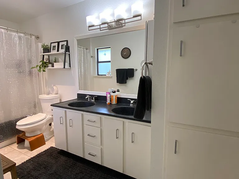 Master bath with granite counters, double vanity and linen cabinet