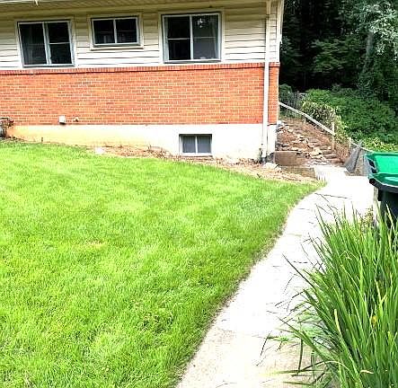 Walkway towards front door. Patio will be at the bottom of the hill going up the back.