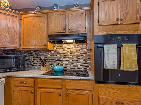 Granite countertops, tile backsplash, and new kitchen appliances