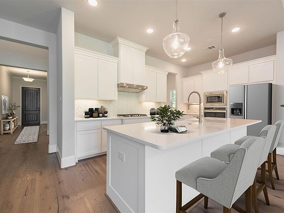 kitchen with white wood cabinets and oversized island