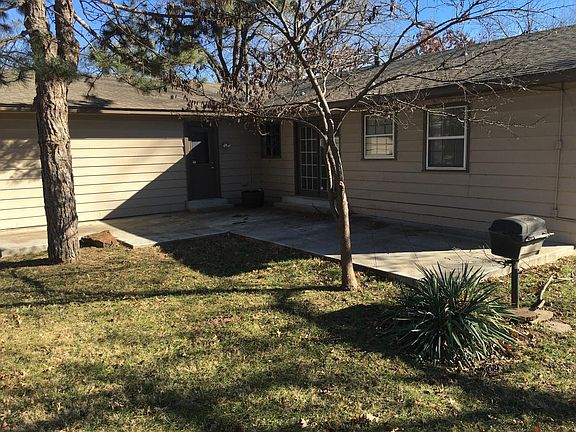 Large back yard patio with gas grill