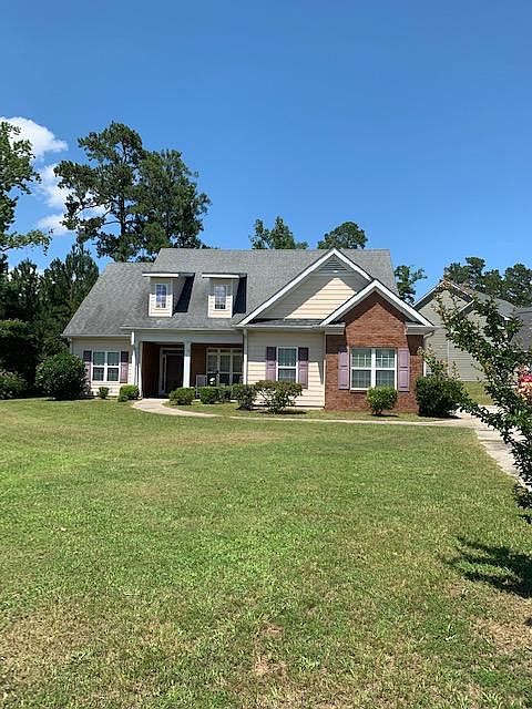 Front view of house, on corner lot.