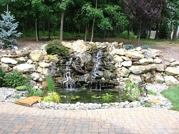 Magnificent Stone Waterfall Cascades to a Koi Pond