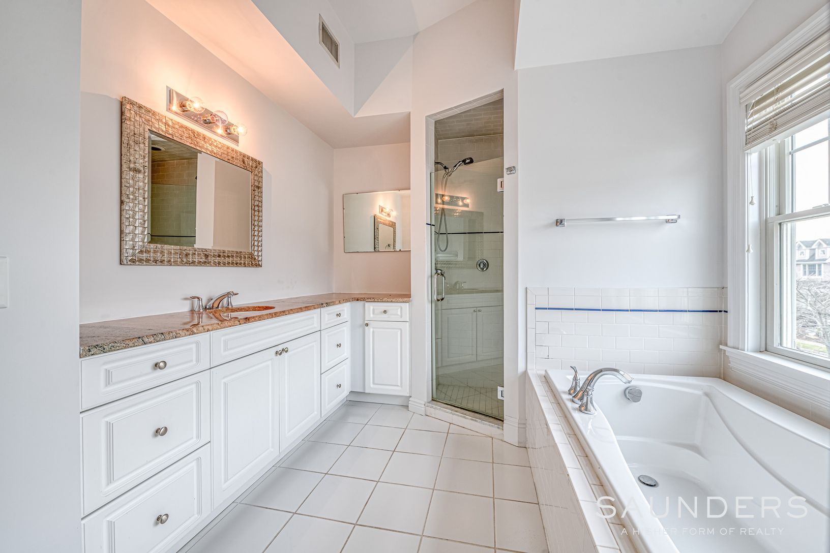  Primary bathroom with double vanities, shower stall, soaking tube and lots of light 
