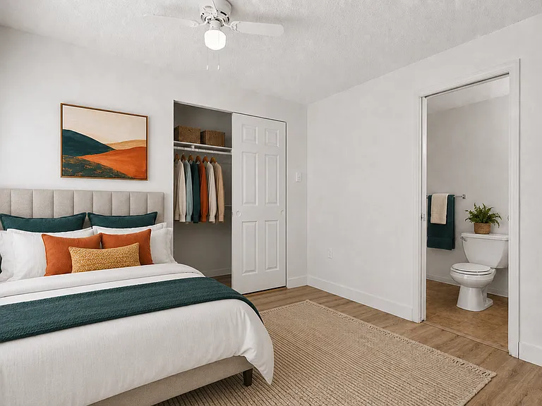 Comfortable bedroom with generous closet storage and convenient ensuite bathroom access at Palisades Apartments. Comfortable bedroom with generous closet storage and convenient ensuite bathroom access at Palisades Apartments.