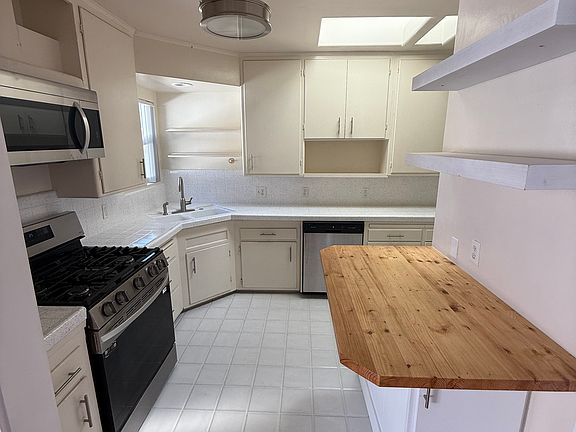 Kitchen with newly resurfaced countertops, anda nice butcher block contrast