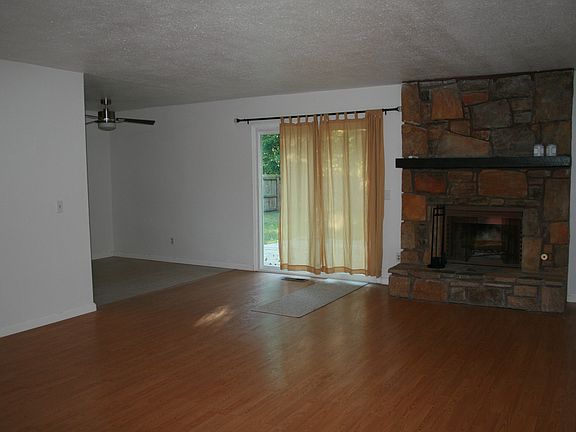 Living area with gas starting wood burning fireplace. New patio door to back yard.