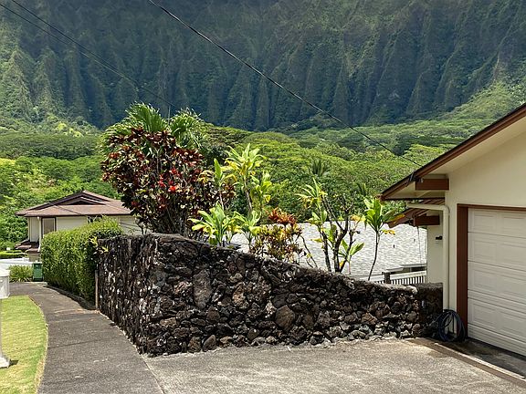 View of garage from street - master bedroom yard behind rock wall