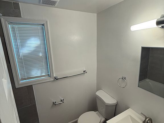 Newly renovated bathroom w/ new waterproof floor, new vanity/sink, new toilet, and new shower/tub