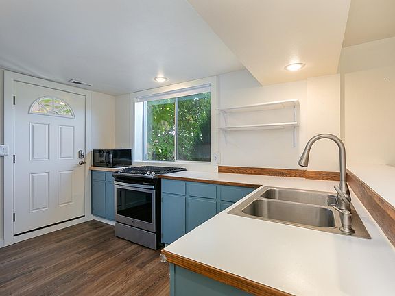 Entry into the kitchen. Gas range and microwave.
