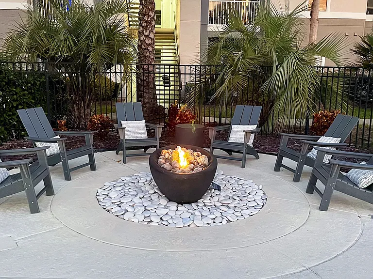 Gather around the inviting fire pit at Banyan Bay, a cozy outdoor space designed for relaxation and connection.