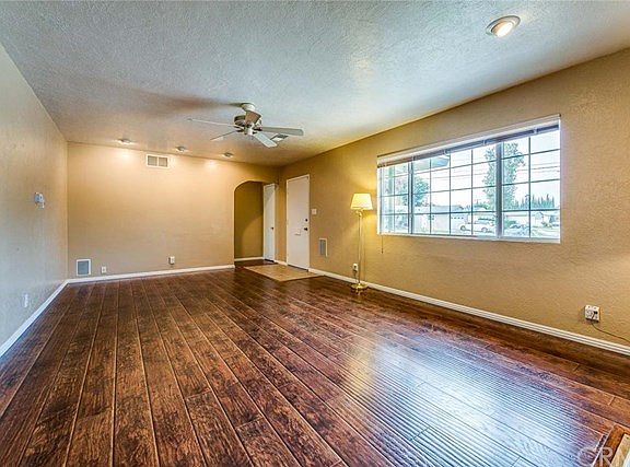 ANOTHER VIEW OF THE SPACIOUS LIVING ROOM