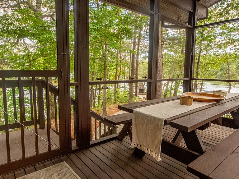 Screened porch overlooking water front.
