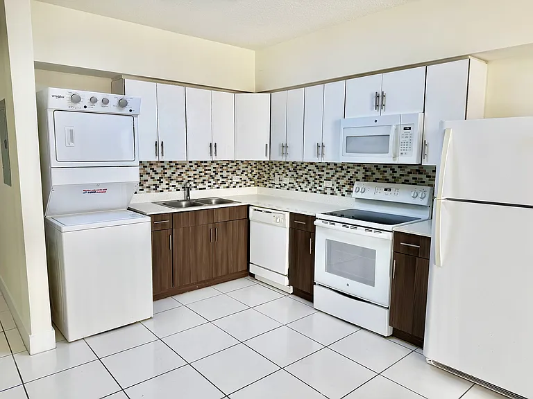 Kitchen featuring a convenient in-unit washer and dryer.