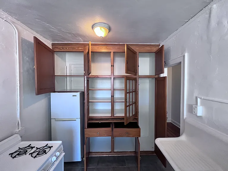 The kitchen offers a magnificent amount of built-in storage and classic wood cabinetry.