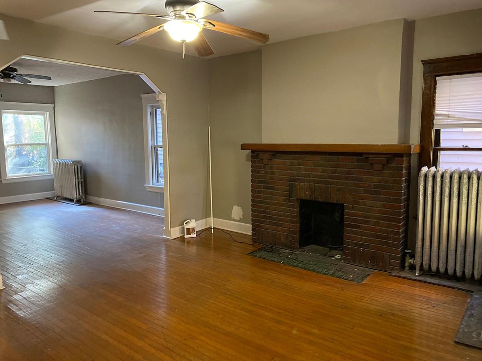 All wood floor with decorative fireplace.