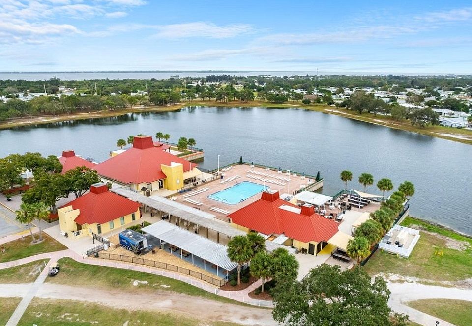 Aerial view of Barefoot Bay Recreational Community, showing lake and Indian River Lagoon.