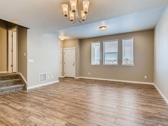 Living area from kitchen. Powder bath at top of landing.