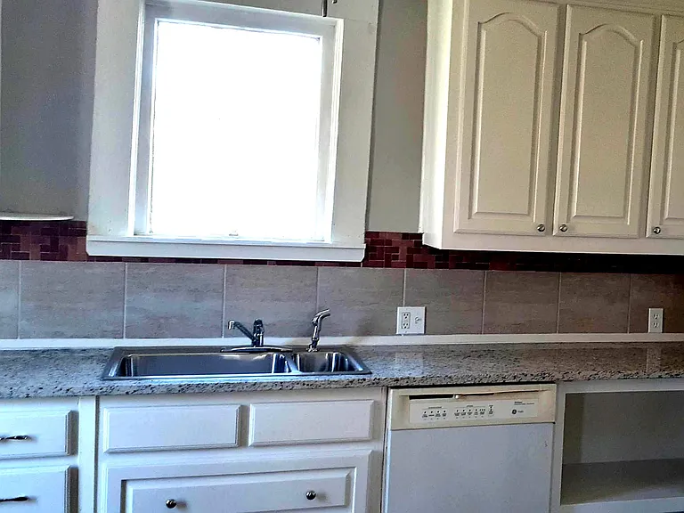 Kitchen with granite counters, and dishwasher