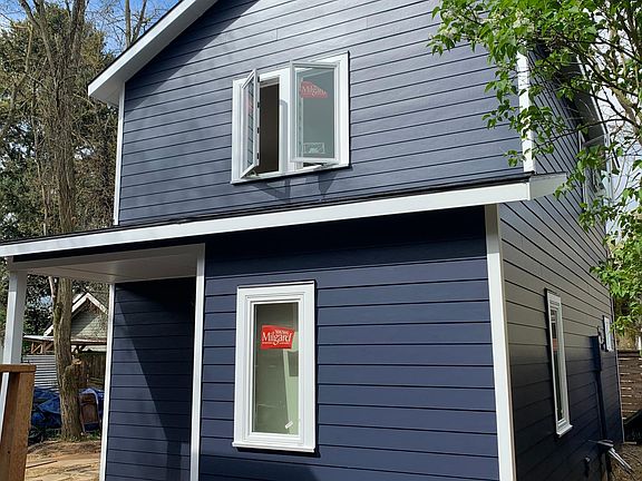 View of front covered entry porch and foyer window for natural lighting