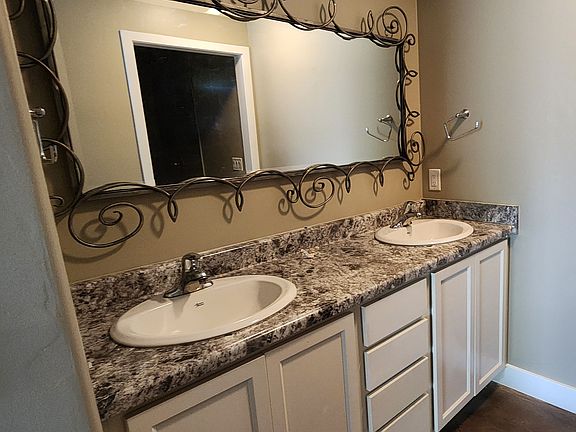 Primary bedroom dual vanities.