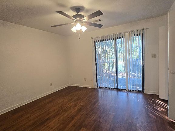 Bedroom with glass door to back patio with lake/ pond view
