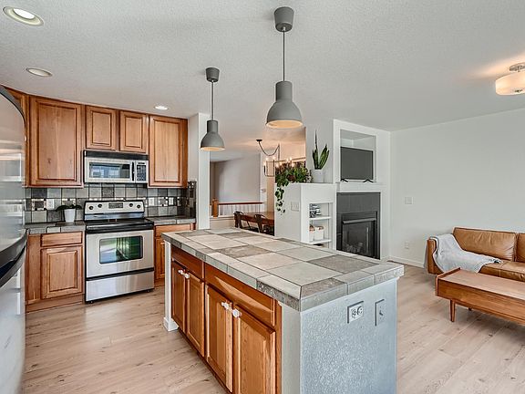 Adjoining kitchen, dining room and family room make for a great entertaining space! The dining room and family room share a gas fireplace for intimate gatherings.