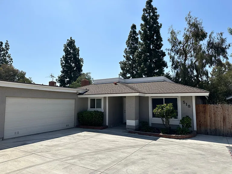 Front of house with 2 car oversized garage. Parking for 2 cars inside of garage and 2 cars in front of garage door.