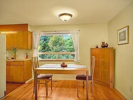 Dining room has hardwood floor and view of landscaped yard
