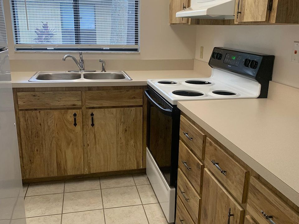 Kitchen with stove, dishwasher, refrigerator, icemaker. Open floor plan with access to living room and dining room.