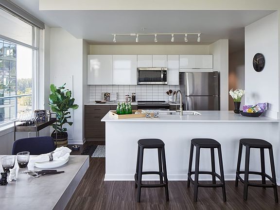 Large kitchen with attached island and stainless steel appliances