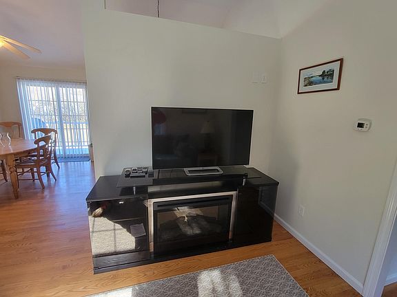 Main Living room looking towards eat in kitchen. Complete with entertainment center and electric fireplace.